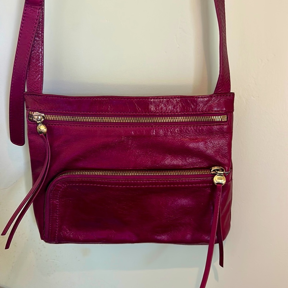 Hobo Cross Body Bag in dark red. 8”X 10” Brass zippered pockets
